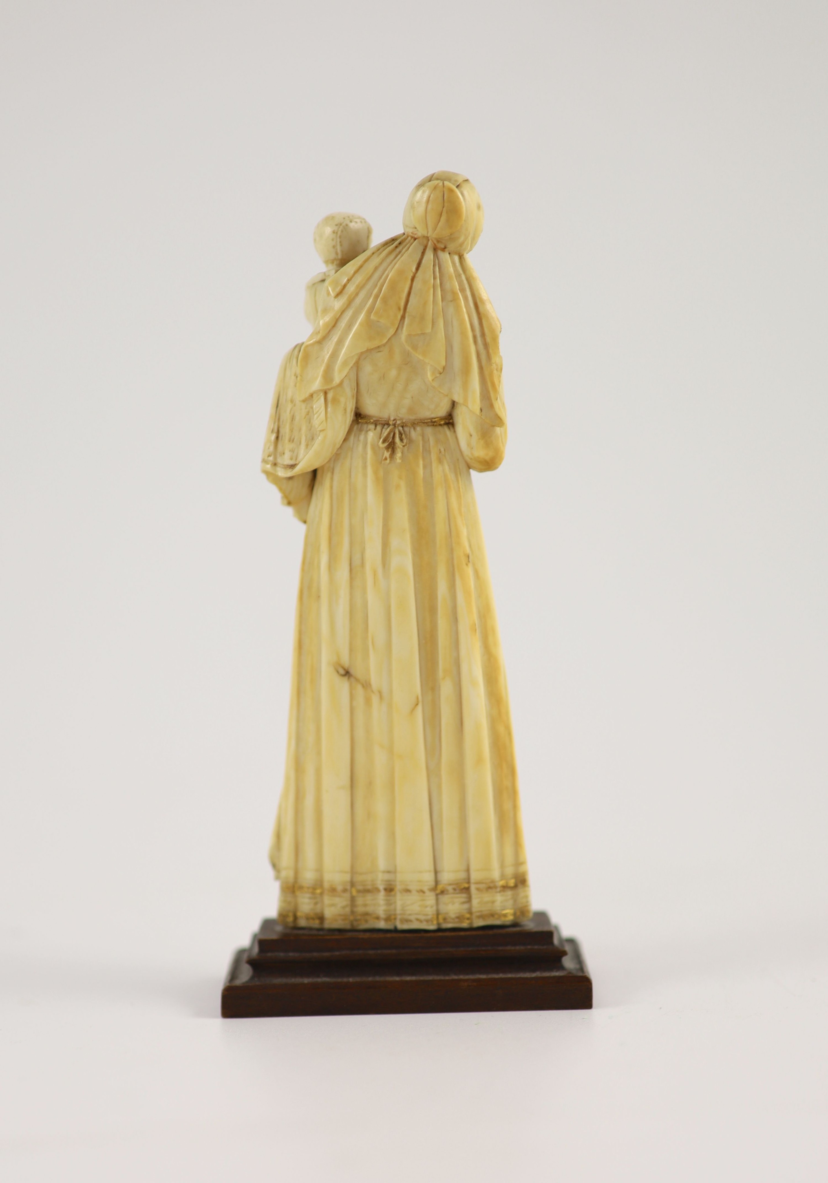 A 17th century French ivory group of a mother and child, ex Hever Castle collection, Height overall 14.5cm.